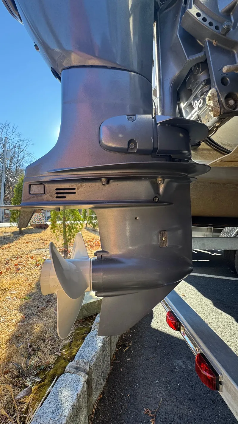 Slide: The Image of Outboard motor of a 2003 Godfrey Sweet Water boat, showing propeller and lower unit. - 22