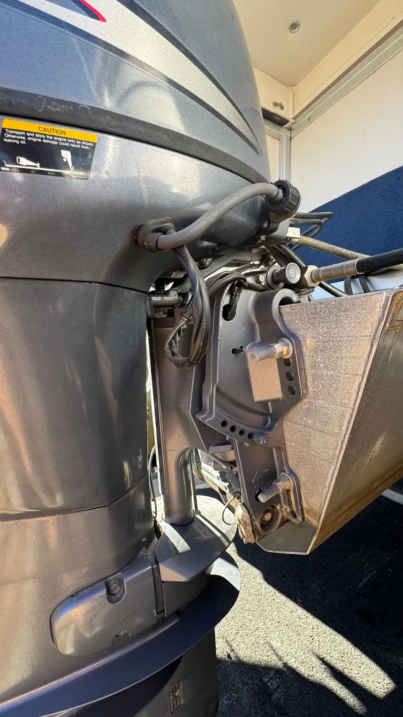 Slide: The Image of Outboard motor of a 2003 Godfrey Sweet Water boat, showcasing mechanical details. - 23