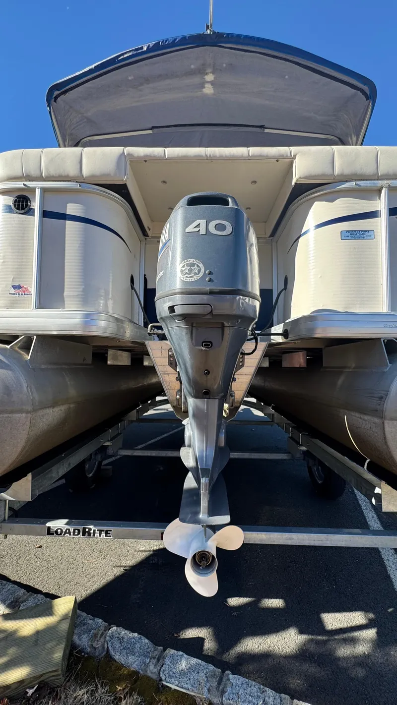 Slide: The Image of 2003 Godfrey Sweet Water pontoon boat with 40 HP outboard motor on trailer. - 24