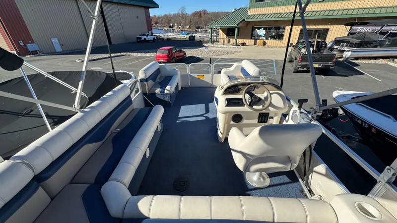 Slide: The Image of 2003 Godfrey Sweet Water pontoon boat interior with steering console and seating. - 6
