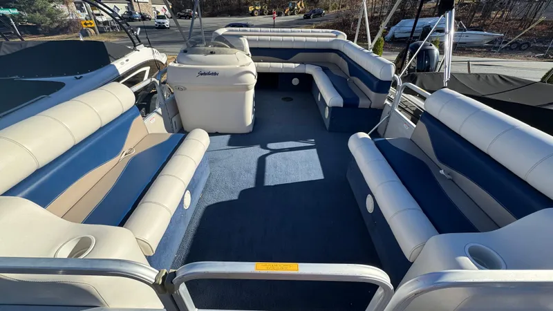 Slide: The Image of 2003 Godfrey Sweet Water pontoon boat interior with blue and white seating. - 7