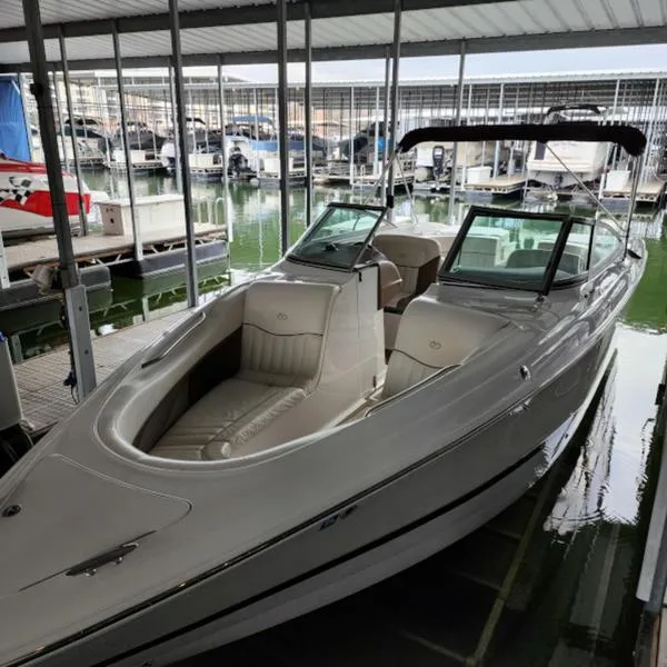 Slide: The Image of 2007 Cobalt 282 boat docked in a marina, featuring sleek design and spacious seating. - 2