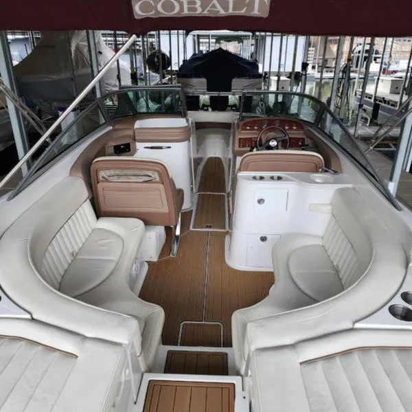 Slide: The Image of 2007 Cobalt 282 boat interior with white seating and wood accents. - 6