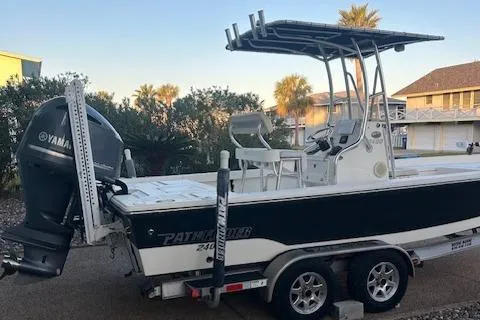 Slide: The Image of 2013 Pathfinder 2400 TRS boat with Yamaha engine on trailer, parked outdoors. - 0