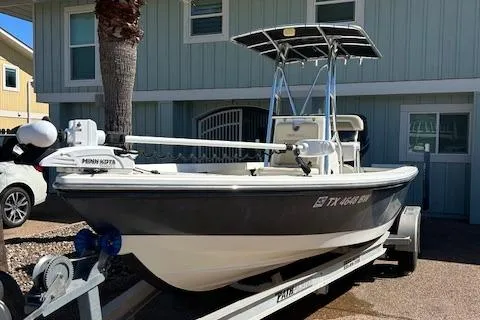 Slide: The Image of 2013 Pathfinder 2400 TRS boat on trailer, parked outside a house. - 1