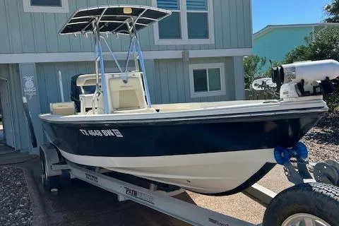 Slide: The Image of 2013 Pathfinder 2400 TRS boat on trailer, parked outside a house. - 3