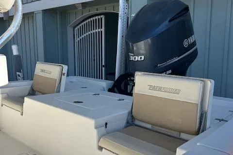 Slide: The Image of 2013 Pathfinder 2400 TRS boat with Yamaha 300 engine, beige seating, and storage compartments. - 7