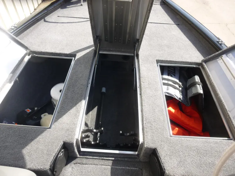Slide: The Image of 2016 Tracker Pro Team 195 TXW boat storage compartments with safety gear and equipment. - 12