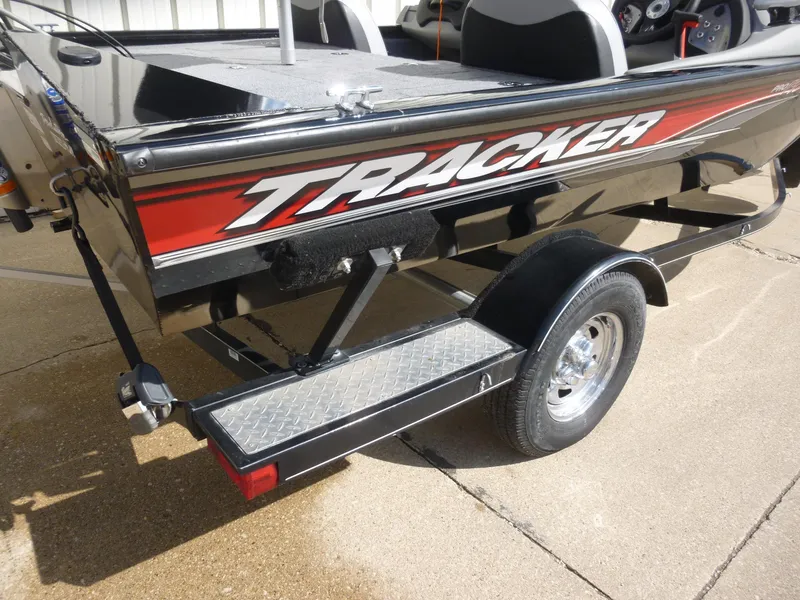 Slide: The Image of 2016 Tracker Pro Team 195 TXW boat, black with red accents, on a trailer. - 19