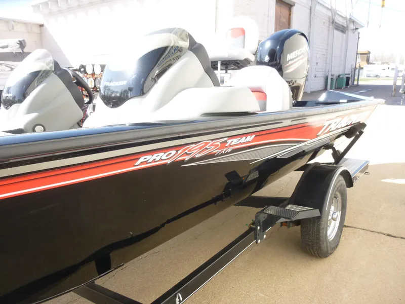 Slide: The Image of 2016 Tracker Pro Team 195 TXW boat with trailer, featuring sleek black and red design. - 22