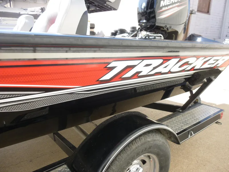Slide: The Image of 2016 Tracker Pro Team 195 TXW boat with red and black design on trailer. - 23