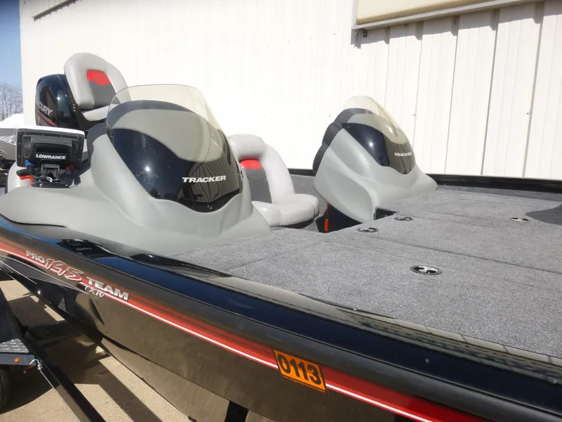 Slide: The Image of 2016 Tracker Pro Team 195 TXW boat with dual seats and console, parked outdoors. - 27