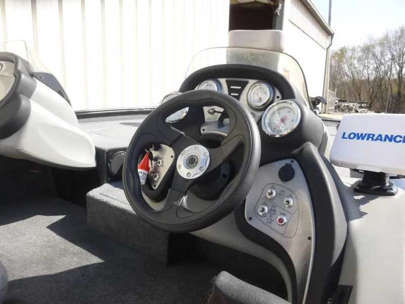 Slide: The Image of 2016 Tracker Pro Team 195 TXW boat dashboard with steering wheel and gauges. - 34