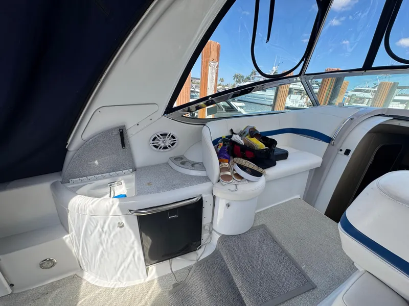 Slide: The Image of 2004 Formula 40 PC yacht interior with seating, mini fridge, and storage. - 13