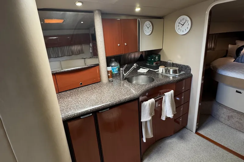 Slide: The Image of 2004 Formula 40 PC yacht interior with kitchenette, featuring sink, cabinets, and modern amenities. - 19