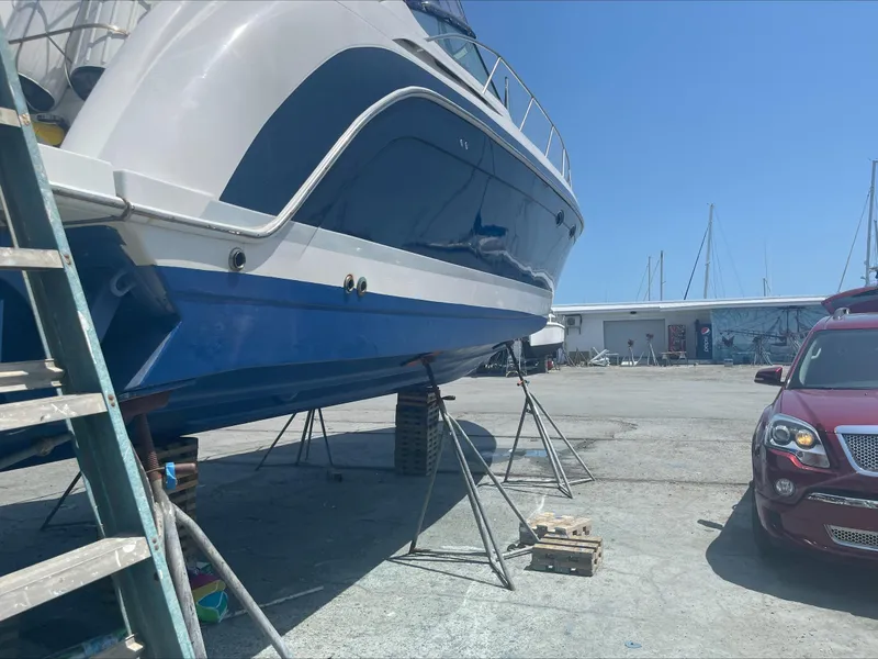 Slide: The Image of 2004 Formula 40 PC yacht on stands in a marina, with a car nearby. - 29