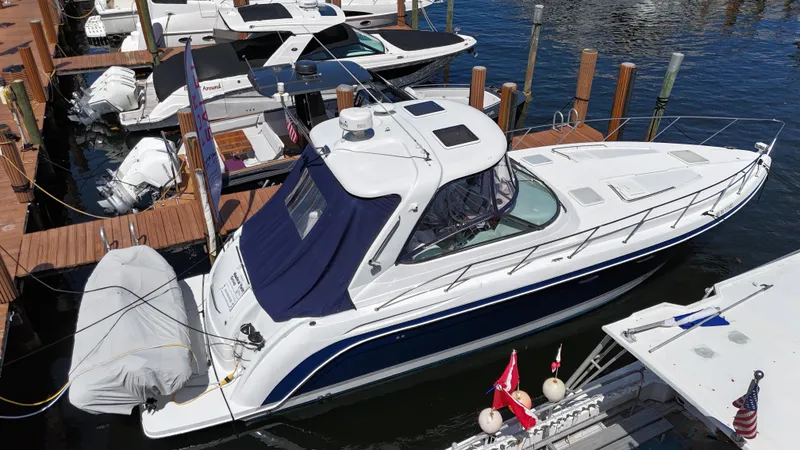 Slide: The Image of 2004 Formula 40 PC yacht docked at marina, featuring sleek design and blue canopy. - 4