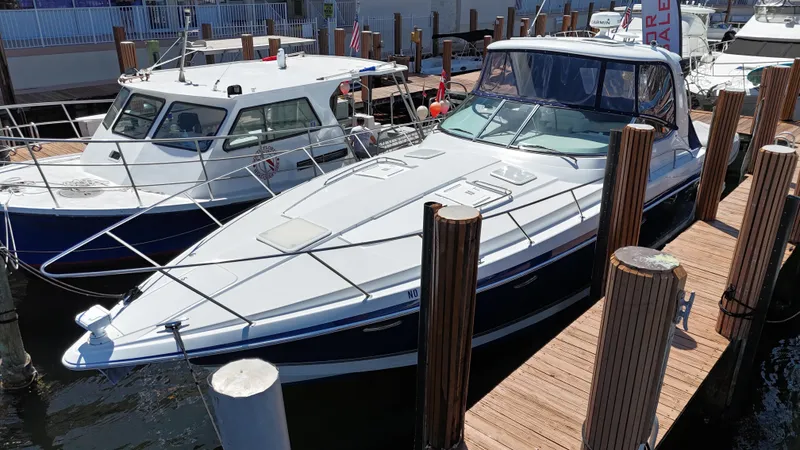 Slide: The Image of 2004 Formula 40 PC yacht docked alongside another boat in a marina. - 5