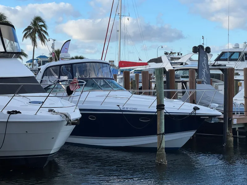 Slide: The Image of 2004 Formula 40 PC yacht docked at marina with palm trees and cloudy sky. - 8