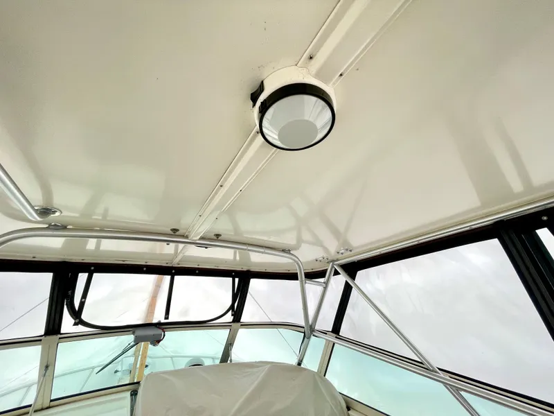 Slide: The Image of Interior view of 1999 Henriques 28 Express Sportfish boat, featuring ceiling and window details. - 10