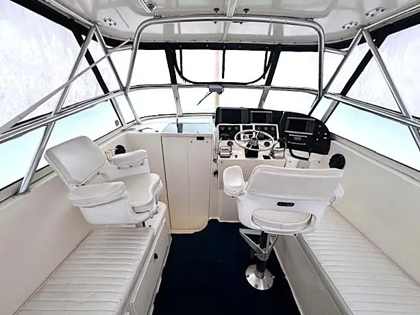 Slide: The Image of 1999 Henriques 28 Express Sportfish boat interior with helm, seating, and navigation equipment. - 5