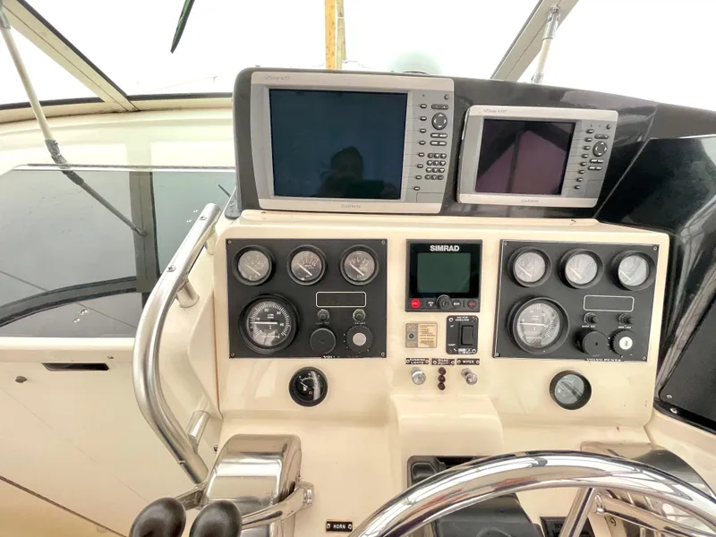 Slide: The Image of 1999 Henriques 28 Express Sportfish helm with navigation screens and control gauges. - 8