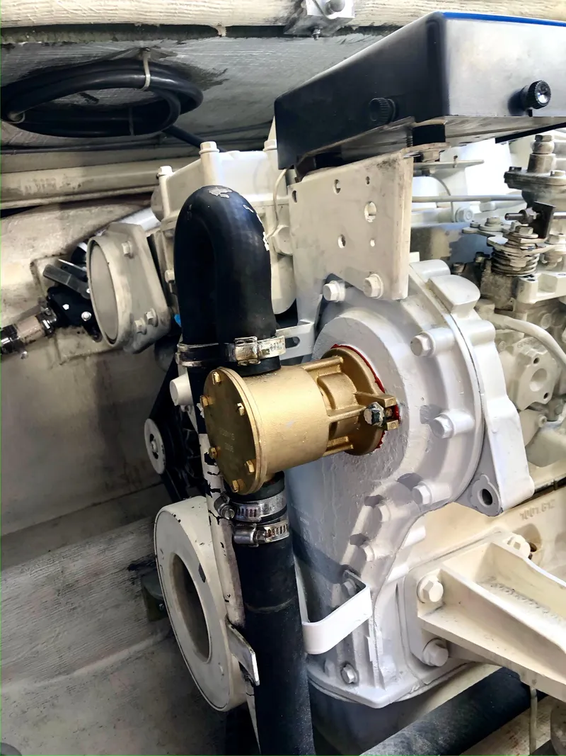 Slide: The Image of Engine compartment of 1999 Henriques 28 Express Sportfish boat, showcasing mechanical components. - 23