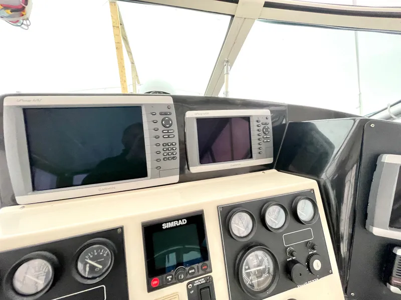 Slide: The Image of Control panel of 1999 Henriques 28 Express Sportfish with navigation instruments and gauges. - 7