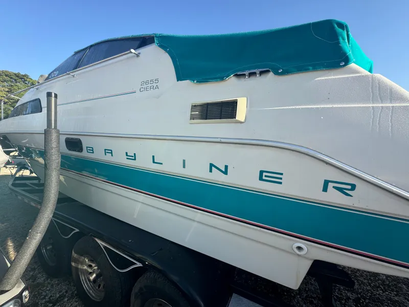 Slide: The Image of 1993 Bayliner 2655 Ciera boat with teal cover on trailer. - 2