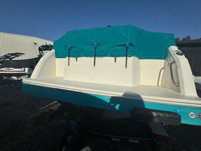 Slide: The Image of 1993 Bayliner 2655 Ciera boat with teal cover, parked on a trailer. - 3