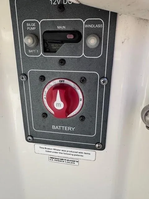 Slide: The Image of Control panel of a 2019 Boston Whaler 230 Vantage boat, featuring battery and switch controls. - 14