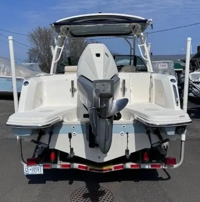 Slide: The Image of 2019 Boston Whaler 230 Vantage boat, rear view with outboard motor, parked outdoors. - 2