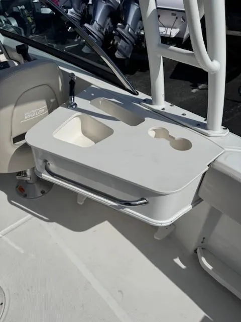 Slide: The Image of 2019 Boston Whaler 230 Vantage boat console with cup holders and storage compartment. - 9