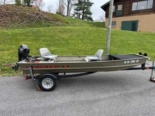 Slide: The Image of 2024 Tracker Grizzly 1436 Jon boat on trailer, parked outdoors. - 4