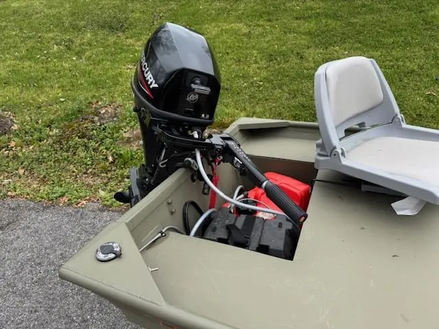 Slide: The Image of 2024 Tracker Grizzly 1436 Jon boat with Mercury outboard motor and seating. - 8