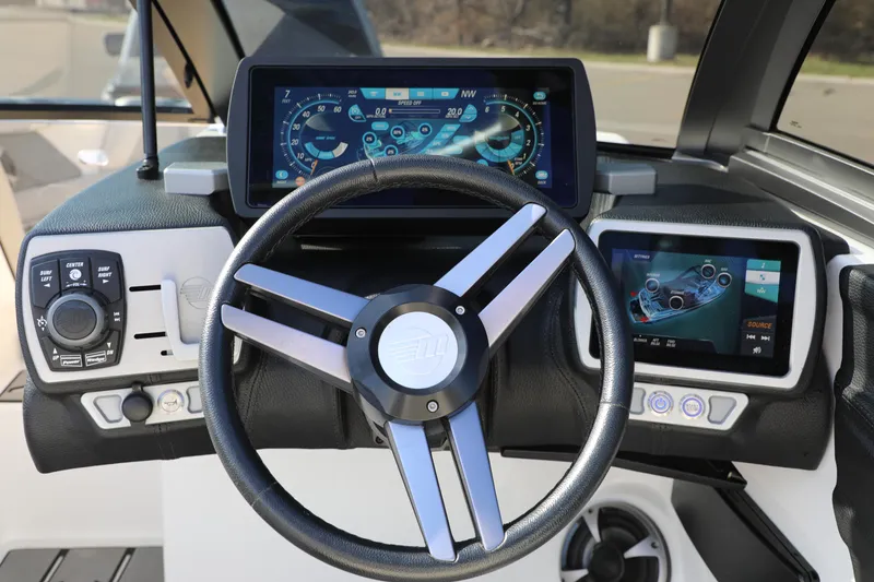Slide: The Image of Steering console of 2019 Malibu Wakesetter 21 VLX with digital displays and controls. - 15