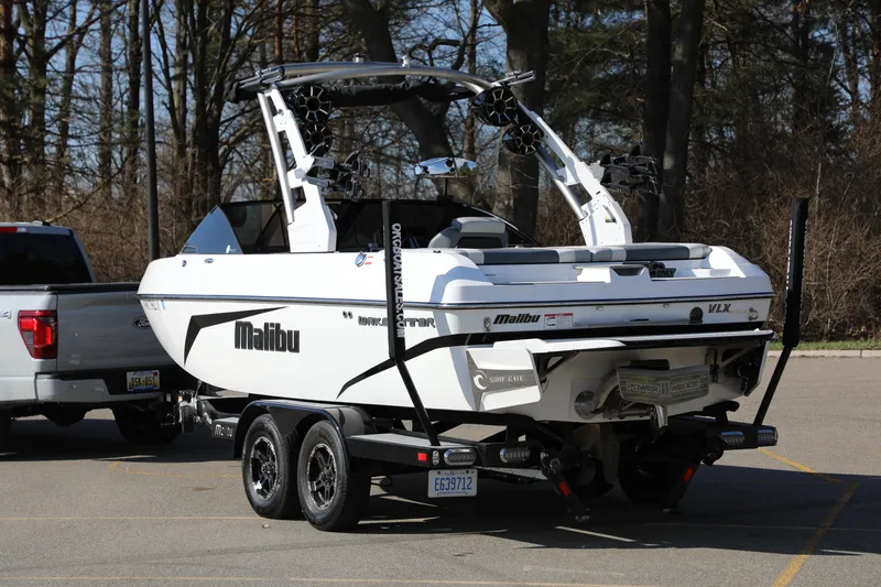 Slide: The Image of 2019 Malibu Wakesetter 21 VLX boat on trailer, parked in a lot. - 21