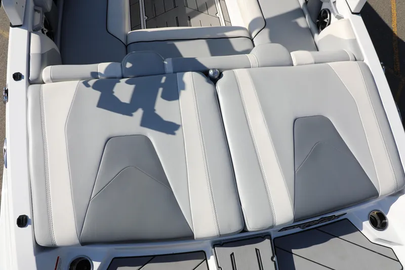 Slide: The Image of 2019 Malibu Wakesetter 21 VLX boat interior with gray cushioned seating. - 9