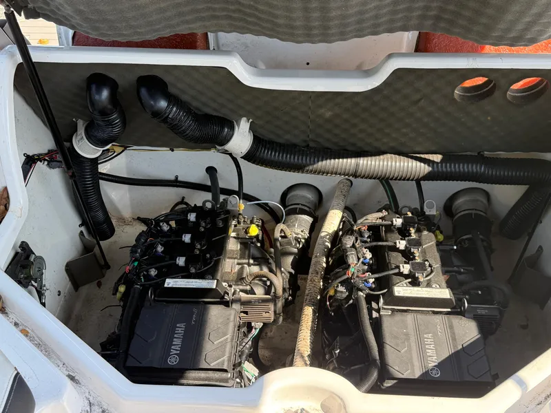 Slide: The Image of 2018 Yamaha SX210 boat engine compartment with dual engines and ventilation hoses. - 11