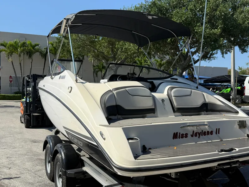 Slide: The Image of 2018 Yamaha Boats SX210 on trailer, featuring "Miss Jaylene II" name, parked outdoors. - 8
