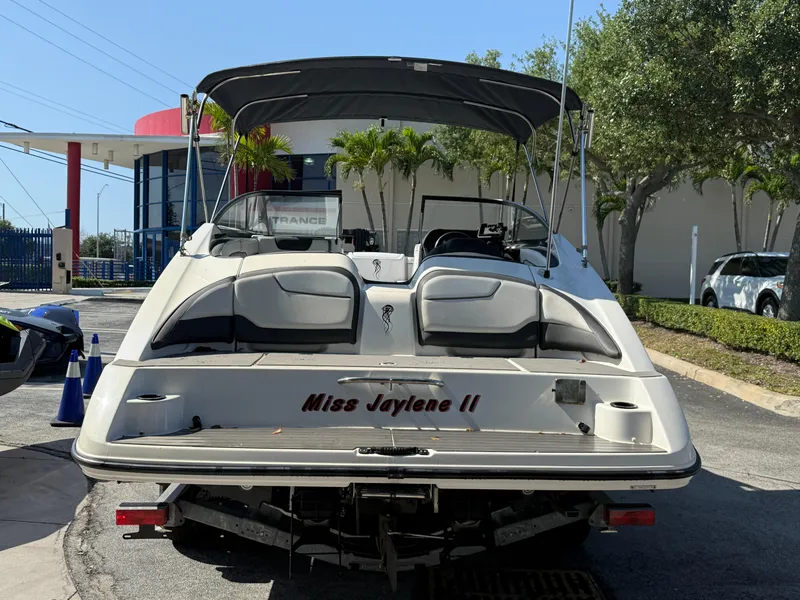 Slide: The Image of 2018 Yamaha Boats SX210 with canopy, parked outdoors, rear view. - 9