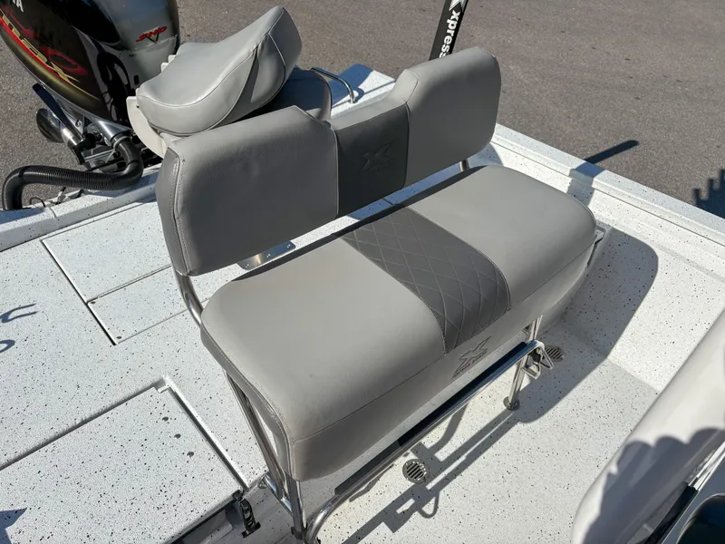 Slide: The Image of 2023 Xpress H22 boat seat with gray upholstery and backrest on deck. - 10