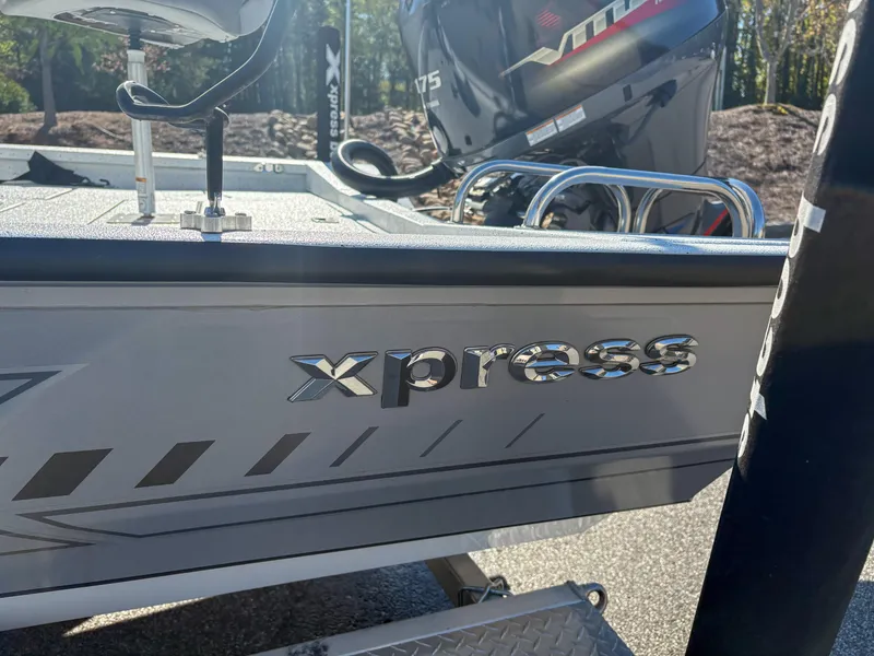 Slide: The Image of 2023 Xpress H22 boat with Yamaha engine, side view showing logo and design details. - 14