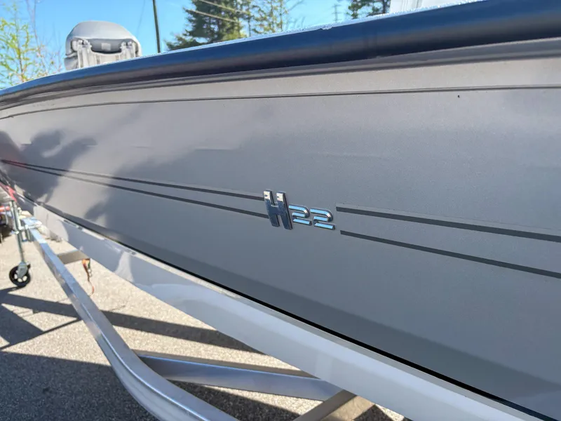 Slide: The Image of 2023 Xpress H22 boat side view, showcasing sleek design and branding. - 15