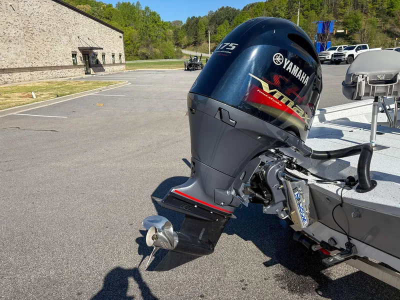 Slide: The Image of 2023 Xpress H22 boat with Yamaha 175 outboard motor in a parking lot. - 3