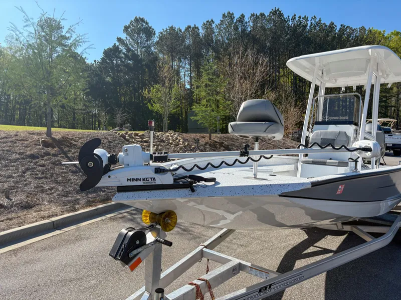 Slide: The Image of 2023 Xpress H22 boat on trailer with Minn Kota trolling motor, parked outdoors. - 6