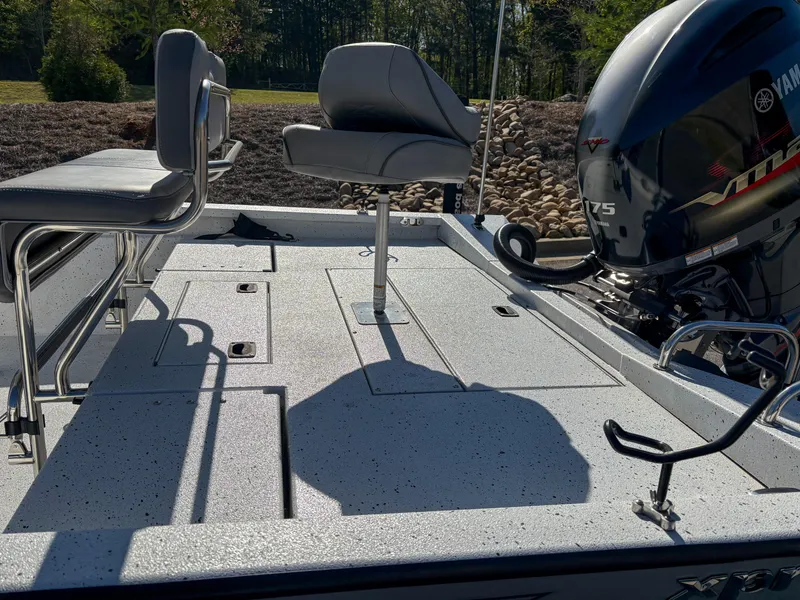 Slide: The Image of 2023 Xpress H22 boat deck with seating and Yamaha motor in a sunny outdoor setting. - 7