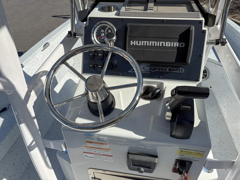 Slide: The Image of 2023 Xpress H22 boat console with steering wheel and Humminbird navigation system. - 8