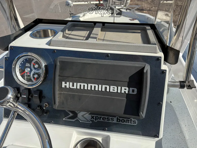 Slide: The Image of 2023 Xpress H22 boat dashboard with Humminbird display and gauges. - 9