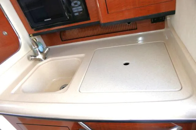 Slide: The Image of 2005 Sea Ray 280 Sundancer galley with sink and countertop. - 14